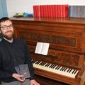Kantor mit Probegesangbuch am Klavier